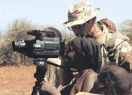 Joint Public Affairs Responsibilities Combat Camera photographer allows a Somali woman to look through the view finder while documenting the delivery of food to the villagers during Operation RESTORE