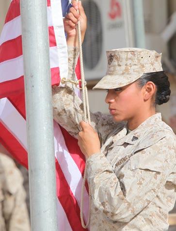 , administrative clerk with Headquarters and Service Company, 1st Marine Logistics Group (Forward), raises the