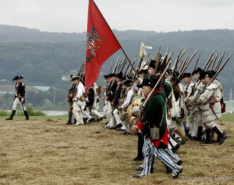 Troops forming The Brigade of the American Revolution march from their encampment set up along the Hudson River