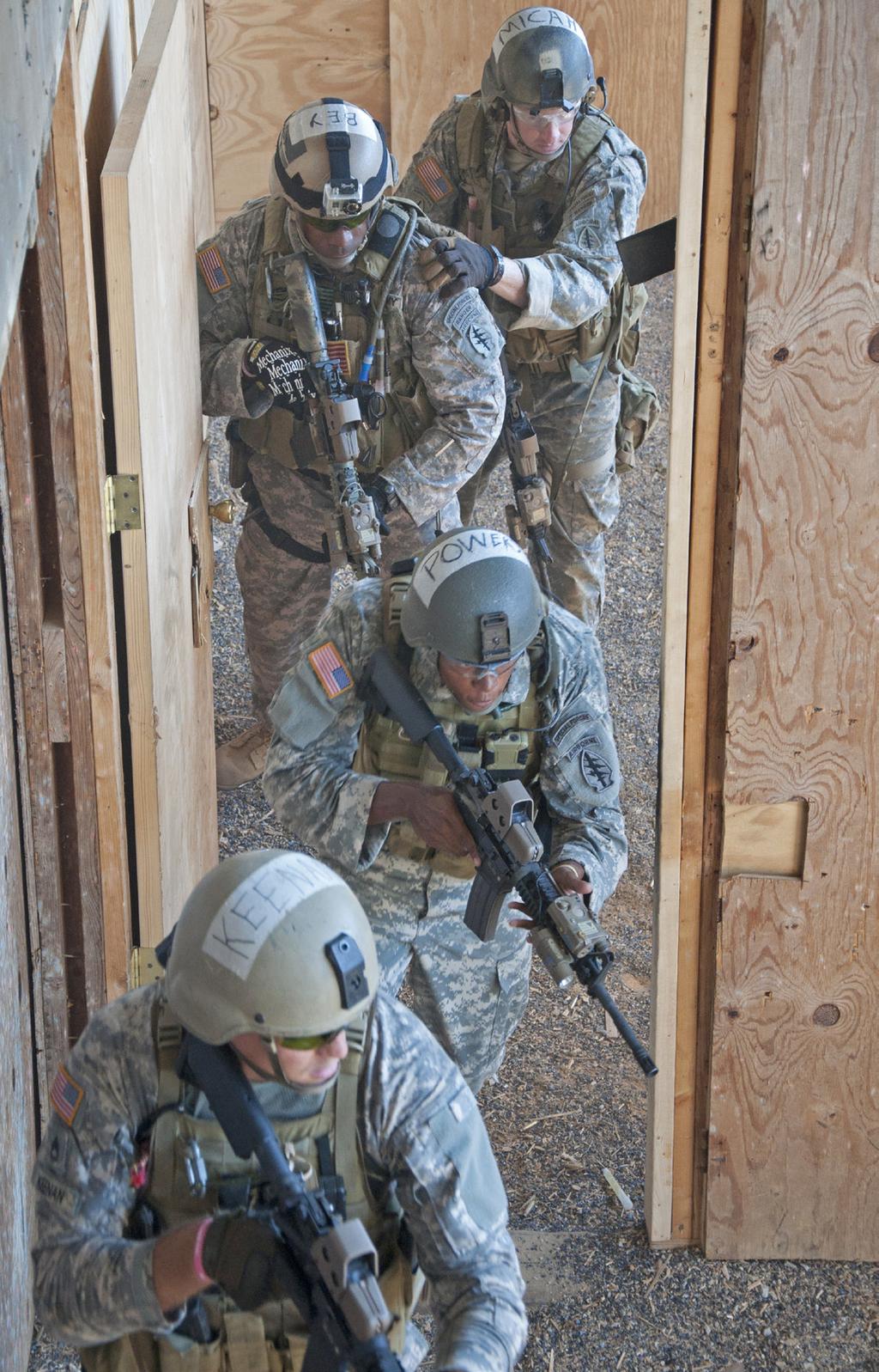 Instructors observe from the catwalk above to assess the Soldier s performance during qualification training at Fort McClellan, September 21, 2012. Command Sgt.