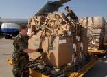 below, airmen prepare to load humanitarian supplies bound for Iraq.