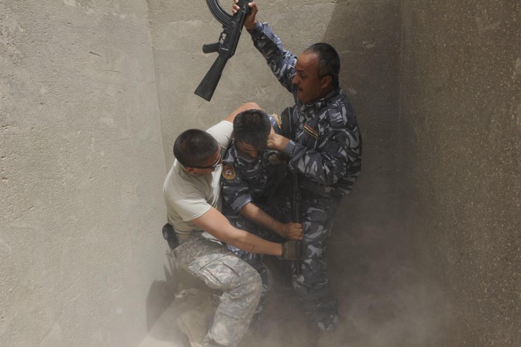 U.S. Soldiers with Delta team, 2nd squad, 1st Platoon, 345th Military Police Company, train high ranking members of the Iraqi Police in Contingency Operating Base Basra, on