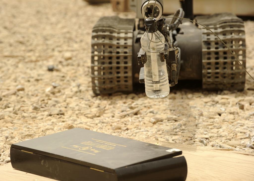 U.S. Navy robot Talon moves towards a mock Improvised Explosive Device (IED) with a water charge in Forward Operating Base Warhorse, Diyala Province, Iraq, July 14, 2010.