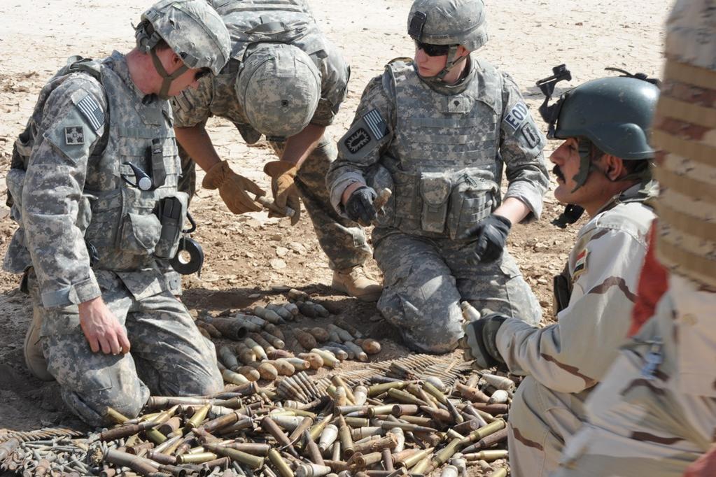 U.S. Soldiers assigned to 725th Explosive Ordnance Disposal (EOD) Team, 441st EOD Battalion, Task Force Troy help Iraqi soldiers with the Bomb Disposal