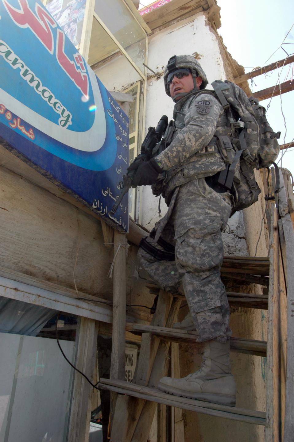 5-5-5 Special Agent Roger Jones, a CID Special Agent assigned to LOGSEC Task Force, conducts a search of an Afghan shop outside of Entry Control