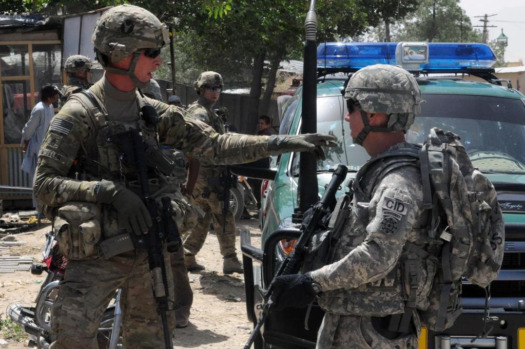 9-9-9 Special Agent Roger Jones, a CID Special Agent assigned to Task Force Vortex, briefs a team leader from the 113 th Cavalry during a