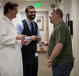 UCLA surgeons Reza Jarrahy (with beard) and Christopher Crisera greet their patient before his exam. Photo by Eric Mencher. The Ronald A.