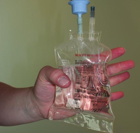 Squeeze the bag to push air into the antibiotic container. 7.