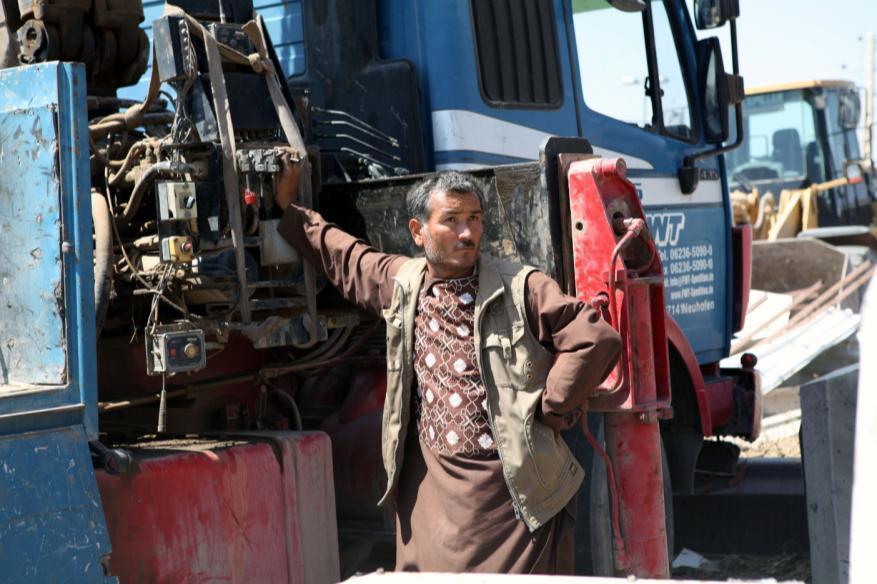 An Afghan local national waits for debris to be loaded on his vehicle at the U.S.