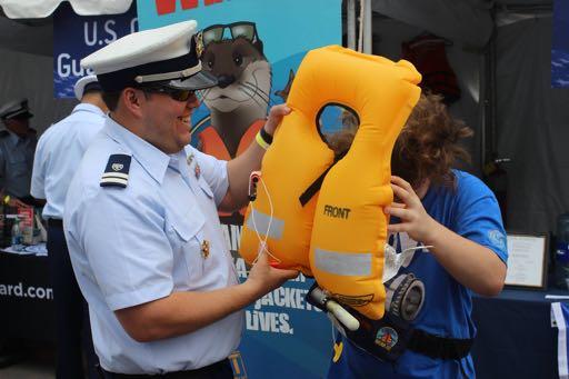 NEW YORK, NY A US Coast Guard Auxiliarist demonstrates the use of an inflatable life
