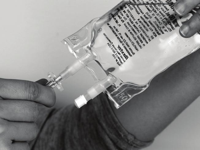 Attach the saline flush syringe to the needleless connector on your IV catheter using a push and clockwise twisting motion until secured together. (See Fig.