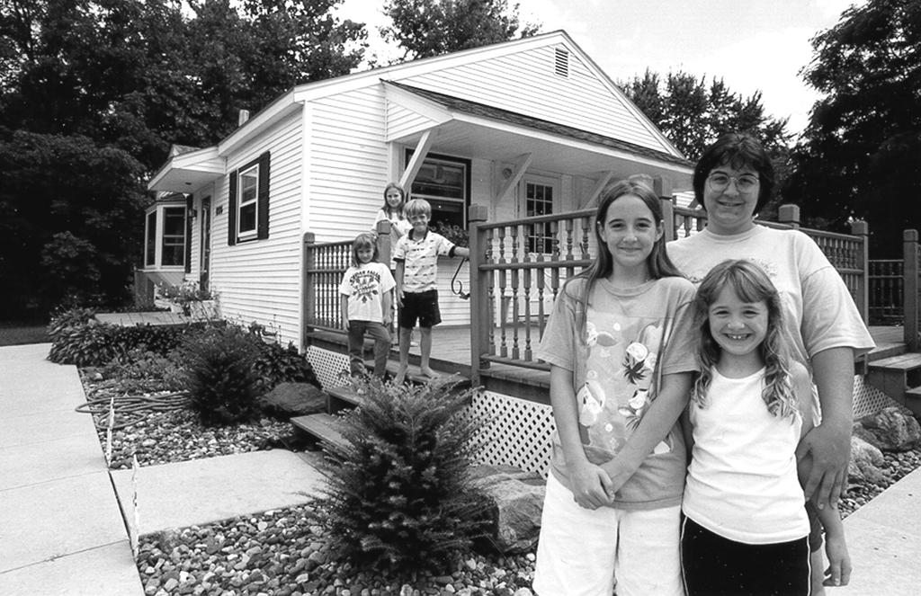 Sandy Albert with her daughters and their friends spends a sunny day at her relocated Cedar Rapids home. FEMA/Photo:Kevin Galvin Sandy Albert and her husband Brian moved the house she grew up in.
