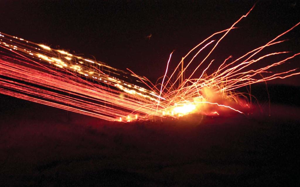 Above, tracer rounds and 2.75-inch rockets from a Super Cobra light up the night sky in the Chocolate Mountains of Southern California on 19 April.