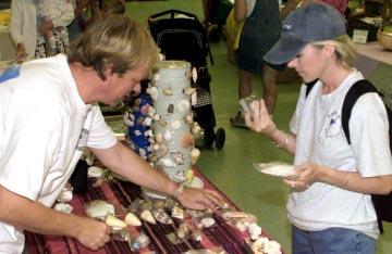 WEATHER Courtesy of Aeromet Decisions, decisions Valerie Gray, right, weighs her options between a pair of shells as Bruce Johnson offers selections at his table at the Kwajalein Art Guild Fair March
