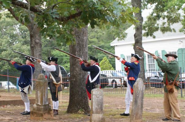 In remembrance In the graveyard of the Old North Baptist Church, men in Revolutionary War uniforms were seen firing their muskets on Saturday and proudly presenting their flags.