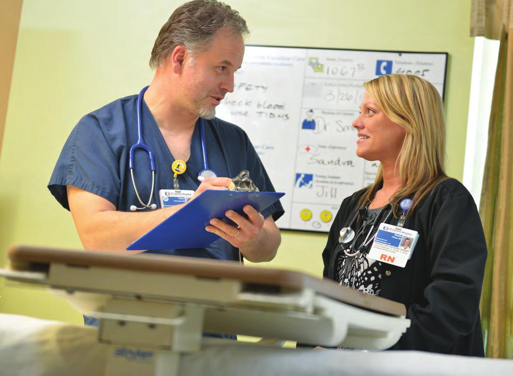 NEW KNOWLEDGE, INNOVATION AND IMPROVEMENTS Nurses Peter Ostrowski, RN, and Sheila Pitfield, RN, of the medical/surgical unit complete a bedside handoff.
