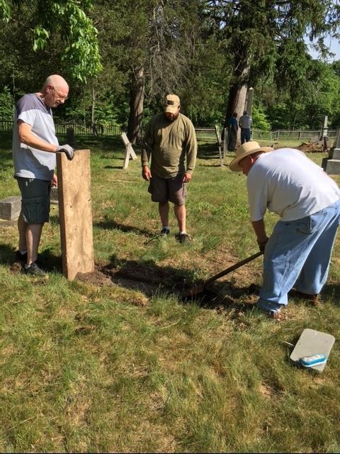 Volunteer Dan Spiece and Bros John Keith and Mike Culp reset a fallen gravestone.