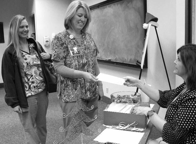 NMHS Christmas Club Checks Exceed $1 Million Sally Finney (left) presents Jerri Cutlip, RN, and Crystal Holcomb, RN, of Women s Hospital with their Christmas Club checks during the Credit Union Day