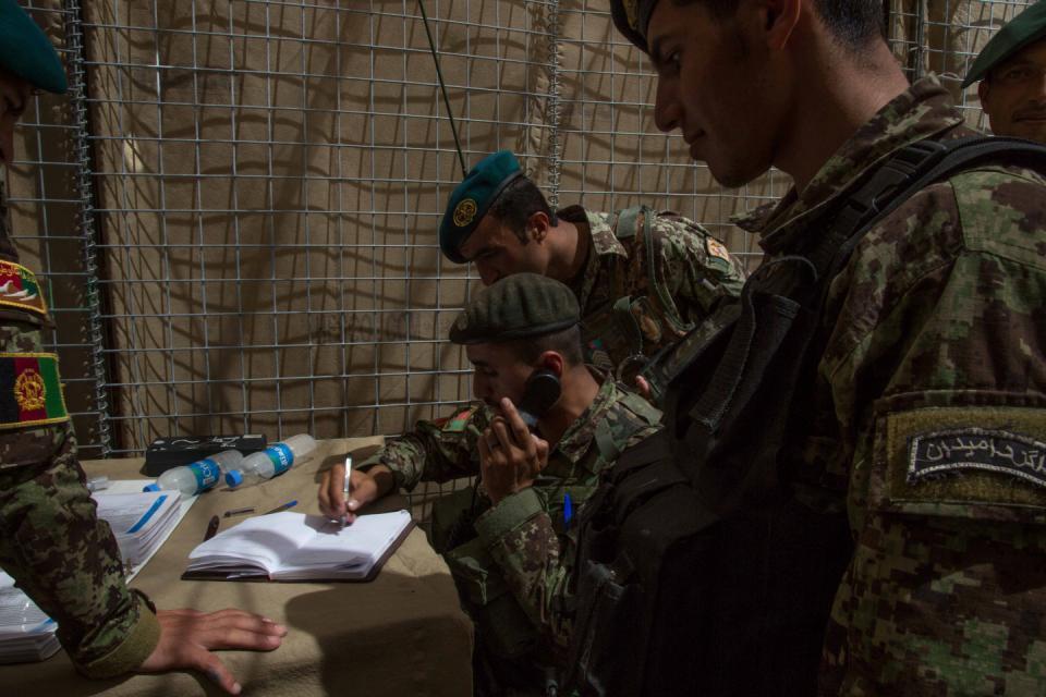 Afghan National Army (ANA) soldiers with the 201st corps receive coordinates, for a D30 howitzer target area, from forward observers during a live fire field artillery exercise on April 18, 2013 at