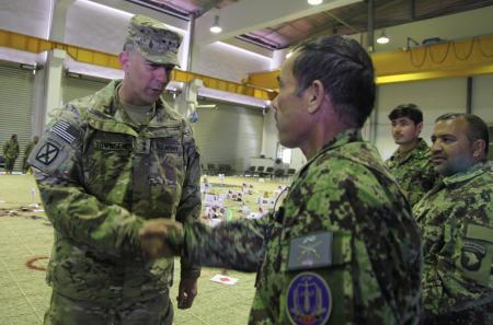 U.S. Army Maj. Gen. Stephen Townsend, commanding general of the 10th Mountain Division, congratulates Afghan National Army Maj.
