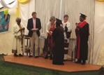 treasure and enjoy, in honour of this achievement. The graduates taking their oath holding a lit candle.