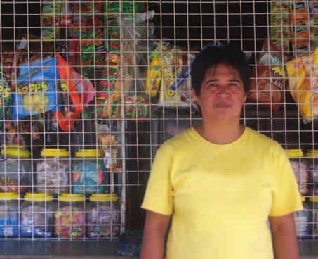 Teresita Dacara in front of her sari-sari store (convenience store) in the Philippines.