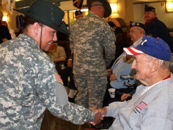 4 From one generation to another... Staff Sgt. Melissa C. Solomon, the Army Reserve Drill Sergeant of the Year, meets Menlo Memorial Home resident Charles Peins, a U.S. Navy veteran of World War II during an event at the home on Nov.