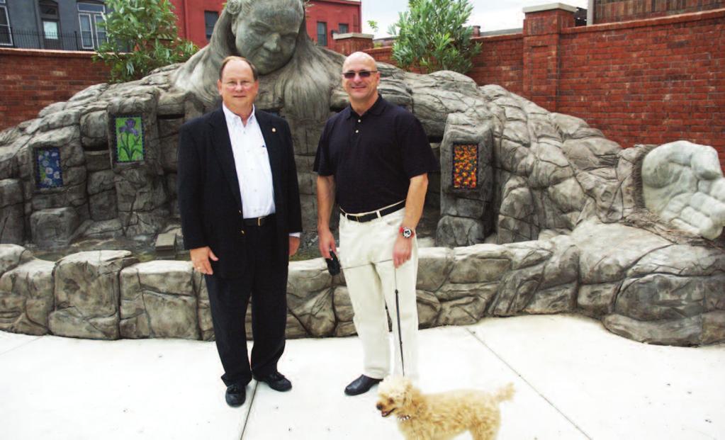 Witcher, left, and downtown North Little Rock developer John Gaudin, right, stand in front of a nearly completed fountain designed by local artist Kevin Kresse.