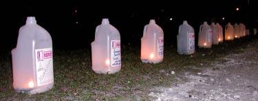 (From page 1) Each luminaria lining the dirt track that splits the softball fields is