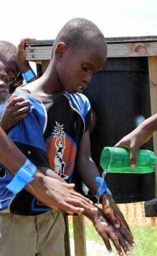 3 Children in La Piste camp are taught good hand washing practices to prevent disease.