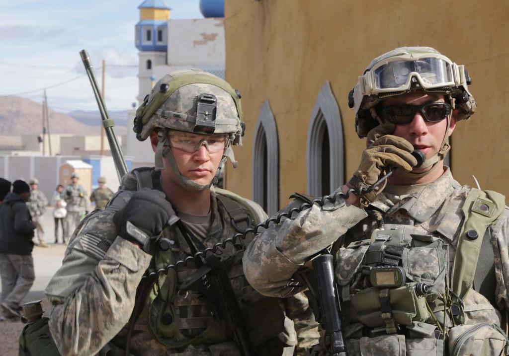 Soldiers communicate over the radio during a mission at NTC on 18 January 2016.