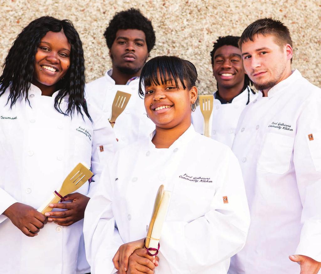 PHOTO CREDIT: Stevie B. Photography Graduates of the Community Kitchen Job Training Program proudly hold their certificates and golden spatulas.