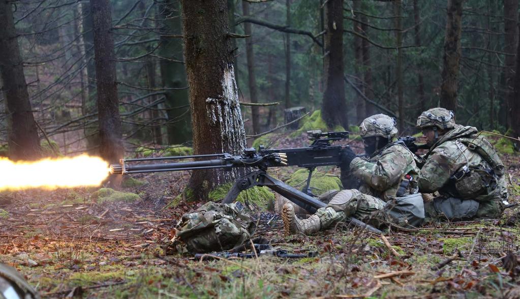 Soldiers from the 1st Battalion, 503rd Infantry Regiment, 173rd Airborne Brigade, provide covering fire while conducting a react-to-contact scenario during Exercise Allied Spirit VI at 7th Army
