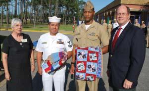 Photo by MC1[AW] Russ Tafuri, USN The two quilts have unique patches sewn on depicting the hospital corpsman caduceus symbol, Marine Corps insignia, and a stitched note of thanks from Roberta Speh,