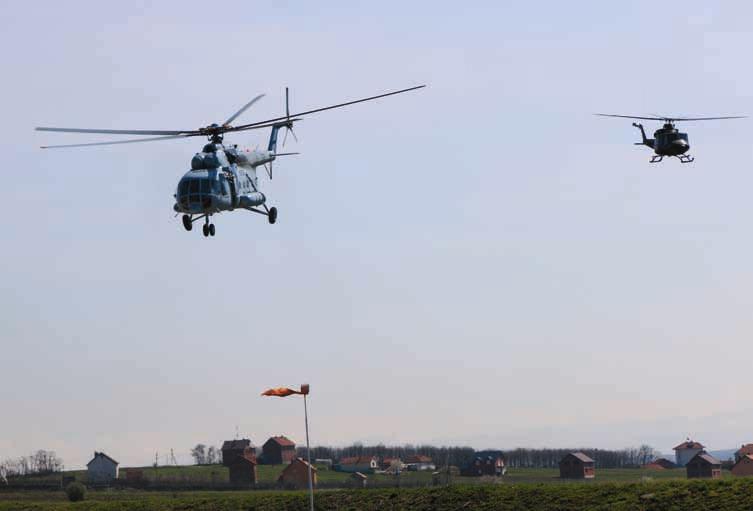 MNBG - E OPERATION GOLD RUSH The sound of helicopter blades spinning cracked through the sky as six helicopters from three different nations zoom from Camp Bondsteel, Kosovo to Camp Maréchal de
