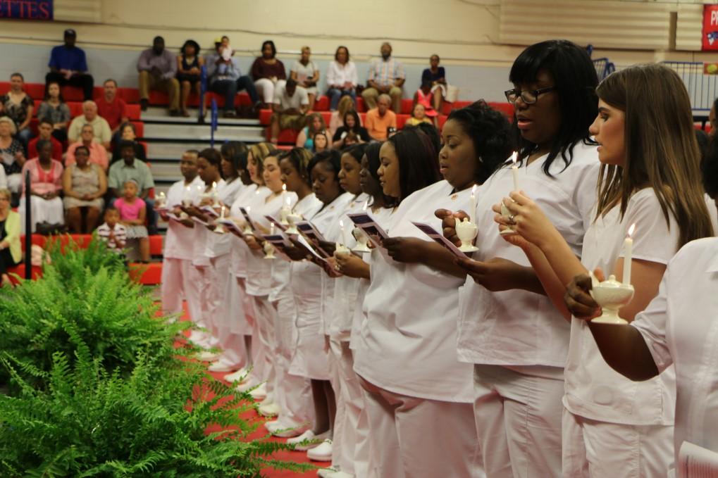presented 18 practical nursing students with pins as symbols of their preparedness to serve as compassionate caregivers. The annual "pinning" was celebrated May 14.