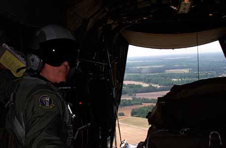 USAF photo by SSgt. Jerry Morrison TSgt. Chuck McNeill, a C-130 load master from Willow Grove ARS, Pa., prepares to drop a pallet in a drop zone at Ft.