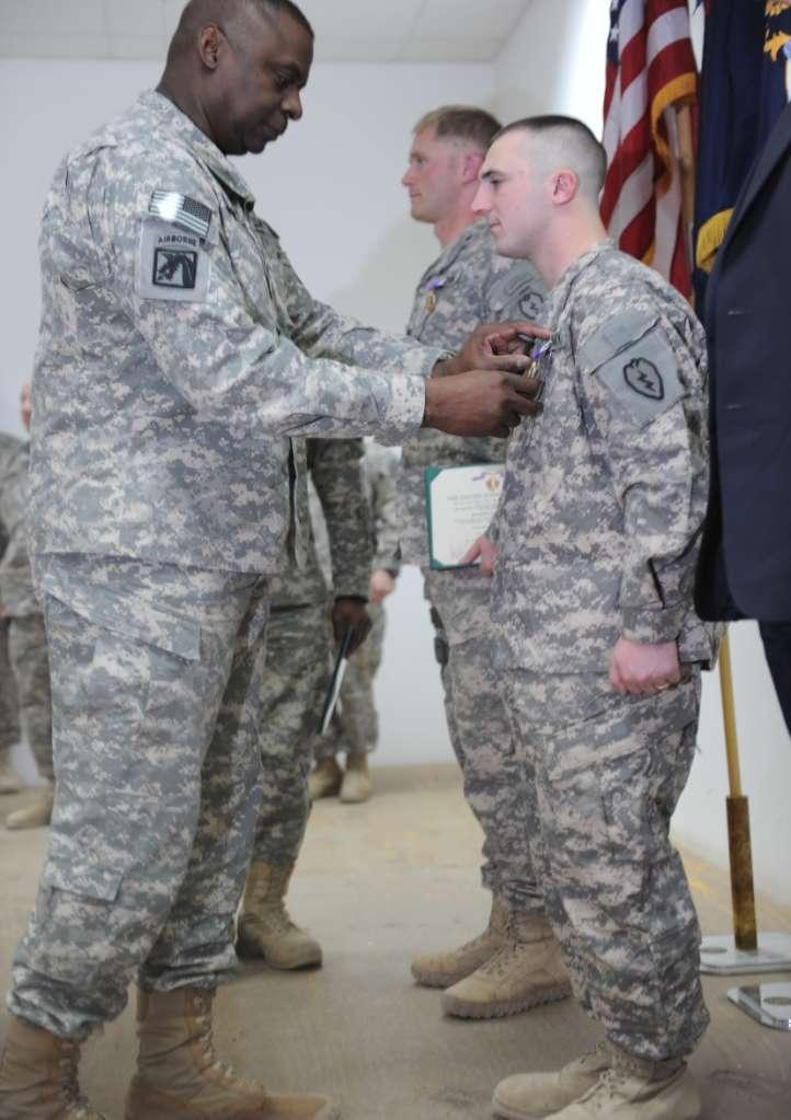 U.S. Army photo by Spc. Charles Smith/Released U.S. Army Gen. Lloyd Austin, commander, United States Forces-Iraq pins Pfc.
