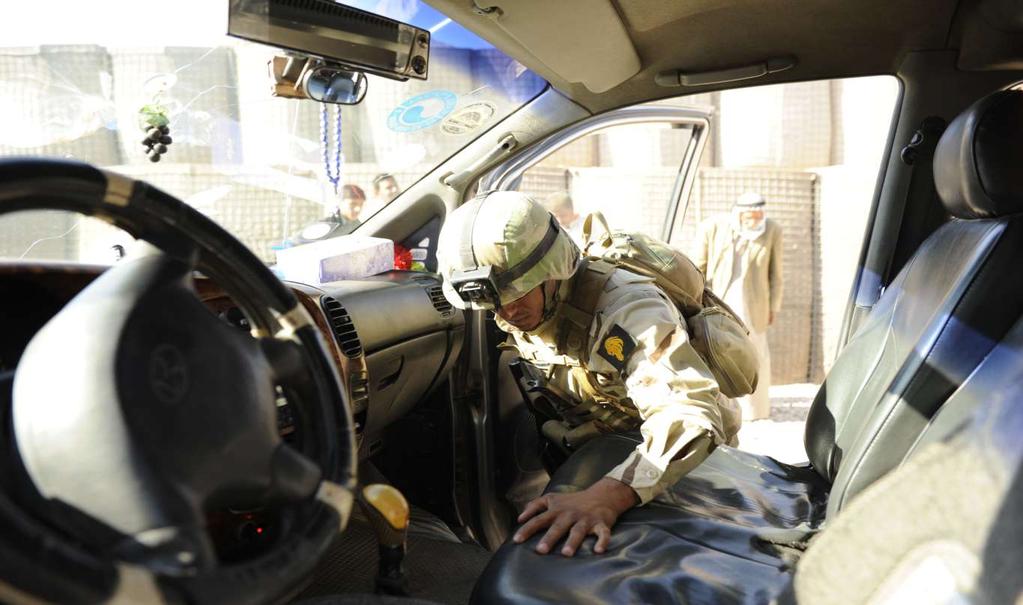 An Iraqi soldier searches through a vehicle at a Diyala checkpoint 2 in Diyala Province, Iraq, November 24, 2010. Iraqi, Peshmerga, and U.S.