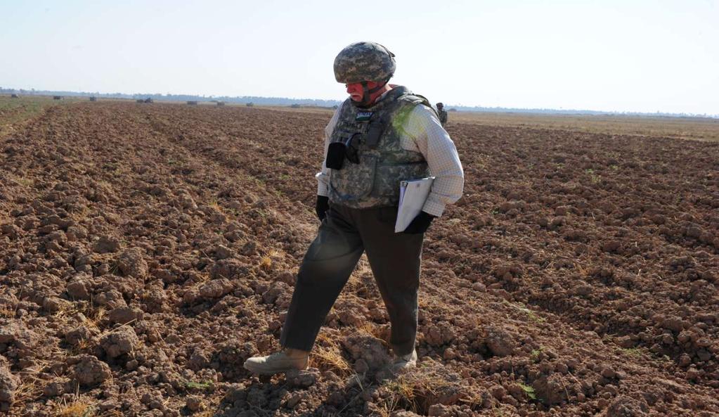 Senior Agricultural Advisor for the Wasit, Iraq Provincial Reconstruction Team George Stickels from Arlington, Virginia surveys a field in the Al Abara village in the Badra district of Wasit, Iraq to