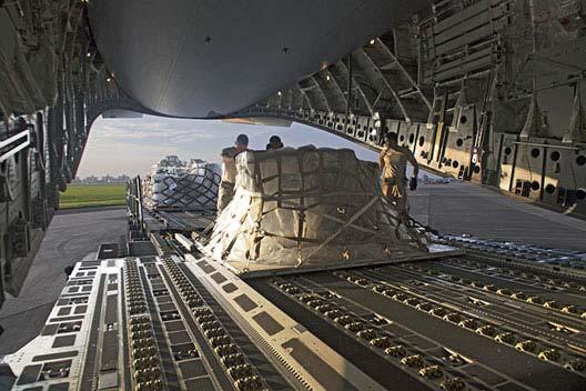Chapter III Airmen from the 730th Air Mobility Squadron push cargo into a C-17 Globemaster III. a few aircraft.
