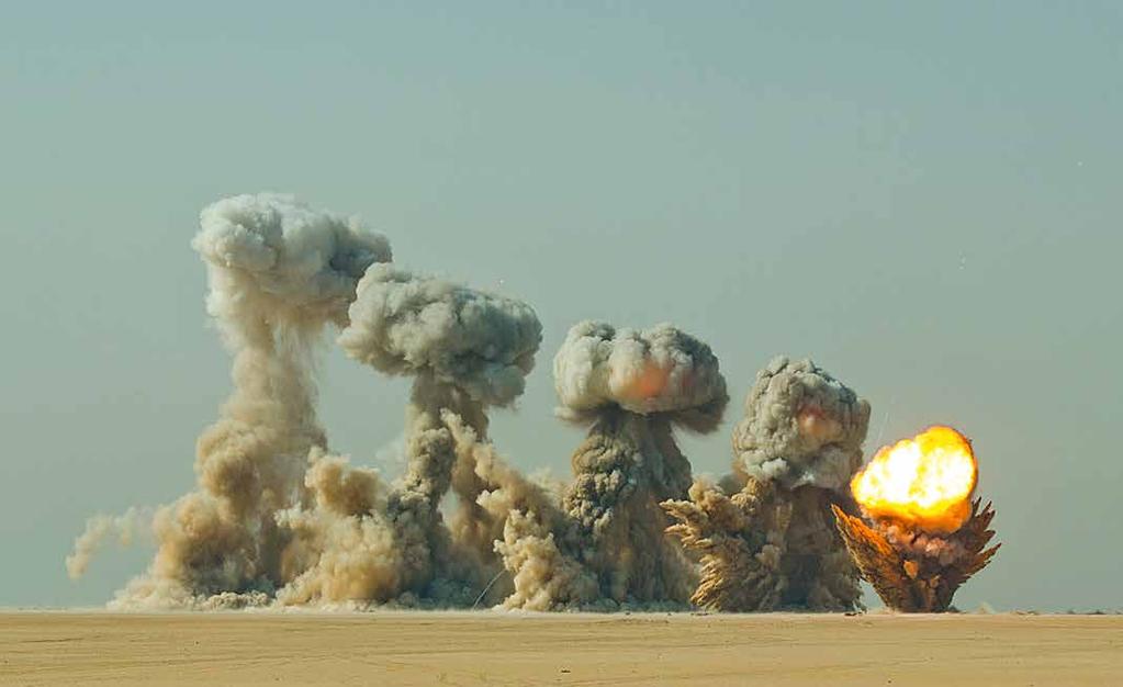 OPERATIONS High-explosive ordnance detonates sequentially across the desert floor during ammunition demilitarization operations conducted by the 261st Ordnance Company under the supervision of the