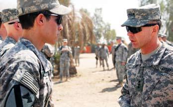 (left), the commanding general of Multi-National Corps Iraq, after receiving a coin at Joint Security Station Shield Sept. 18. Reading, Penn. Native, Pfc.