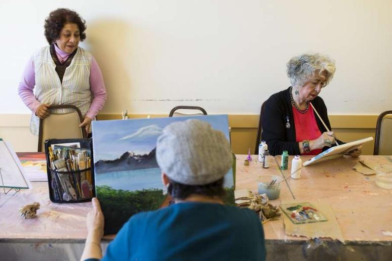 Olinda Marti-Volkoff (right) works on her painting in a class at San Francisco s On Lok 30th Street Senior Center. She says she couldn t afford her living expenses without Medicare.