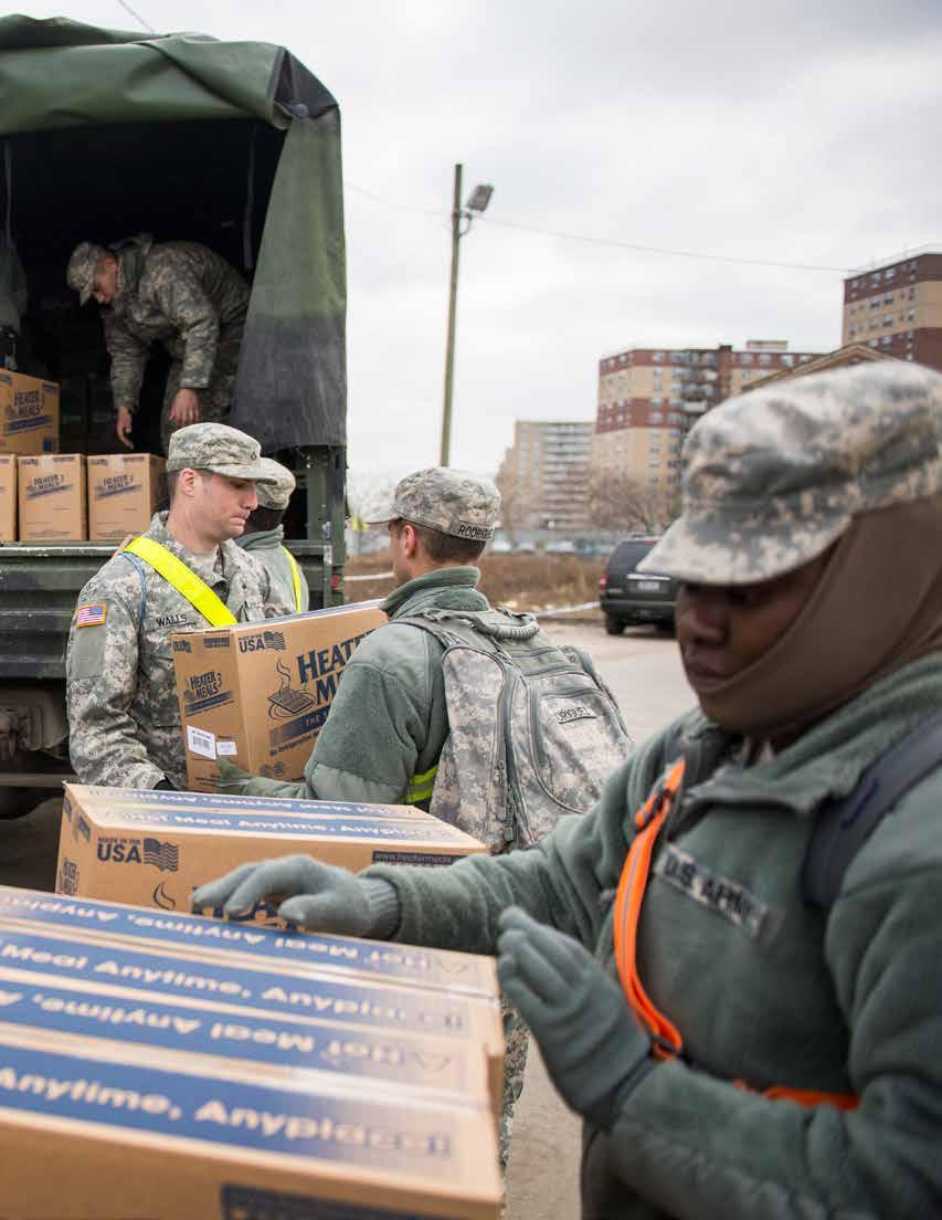 National Guardsmen from the 42nd Infantry Division help deliver supplies to Hurricane Sandy victims in Far Rockaway, New York.