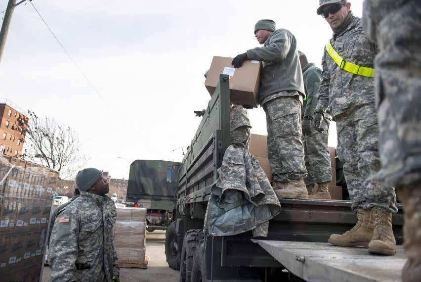 National Guardsmen of the 42nd Infantry Division help deliver supplies to Hurricane Sandy victims at distribution sites in Far Rockaway, New York, on Nov. 19, 2012.