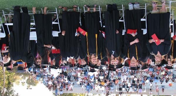 Below, left, students smile in anticipation of receiving their hard-earned diplomas.