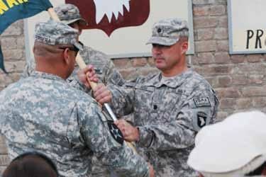S. Air Force Lt. Col. John Walker, incoming Laghman PRT commander, as he hands the guidon to U.S. Army Sgt. Maj.
