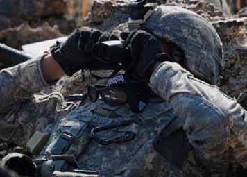 , watches activities with his binoculars near Forward Operating Base Kalagush on Oct. 30. Getting positive identification of potential targets minimizes collateral damage.