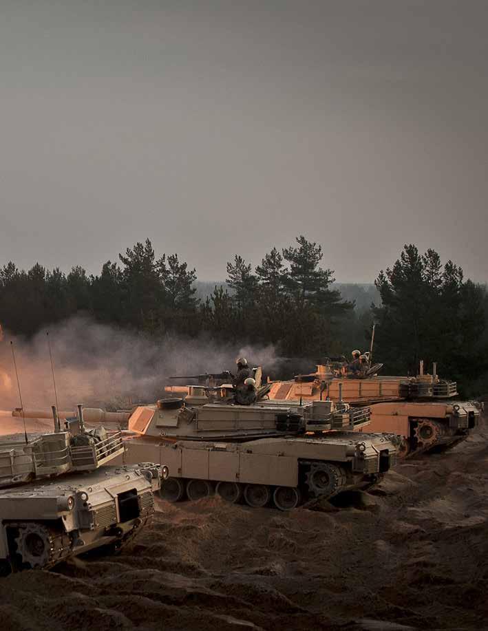 U.S. Soldiers fire ceremonial rounds from M1A2 Abrams tanks at the Adazi training area in Latvia in November